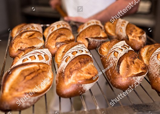 taking bread from the oven